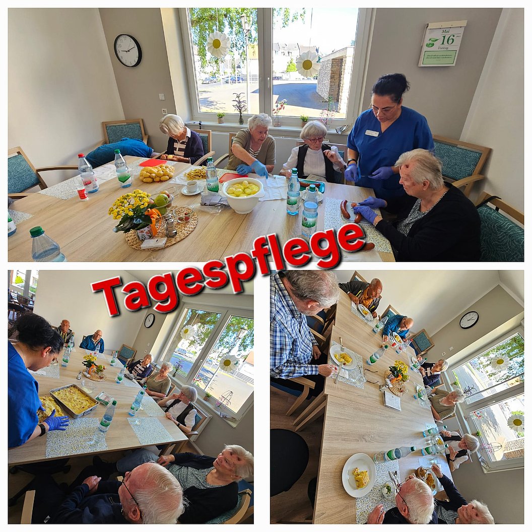 Mehrere ältere Menschen sitzen an einem großen Tisch in einem hellen Raum, eine Pflegekraft steht dabei, auf dem Tisch stehen Wasserflaschen und Obstschalen.